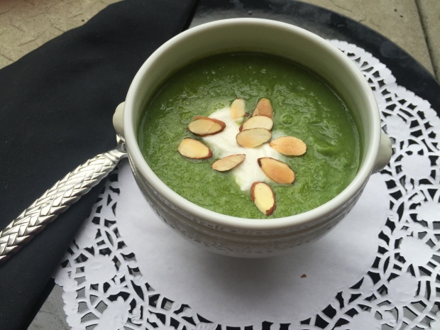 Healthy Broccoli Soup Garnished with Sour Cream and Almonds